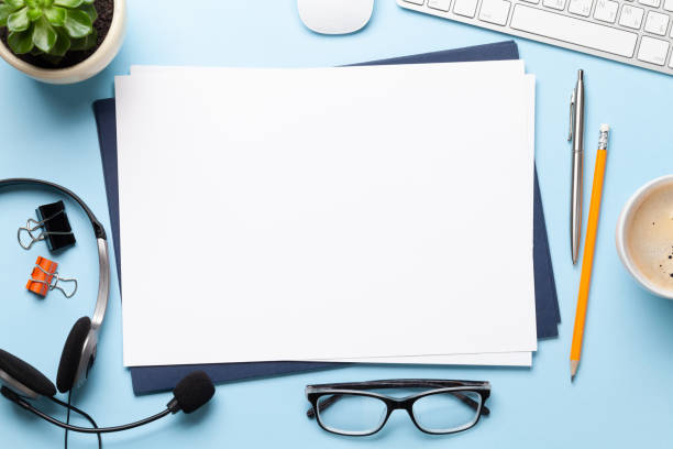 istock Office desk with headset and supplies 1285074240