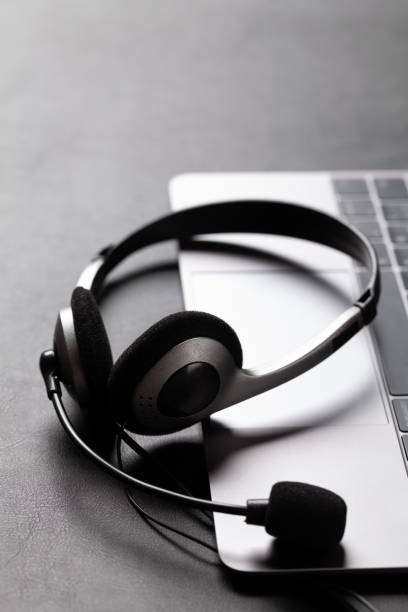 istock Office desk with headset and laptop 1285074405