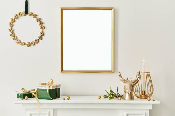 istock Christmas composition with gold mock up poster frame, white chimney and decoration. Christmas trees and wreath, candles, stars, light and elegant accessories. Template. 1285075704