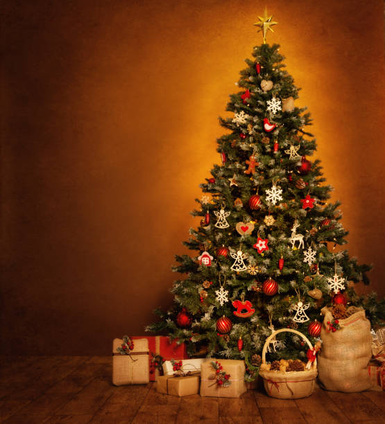 Christmas Tree Gift Boxes, New Year Holiday Retro Decoration Stack of Presents, Xmas Tree decorated with Hanging Toys, Baubles over Brown grunge Background