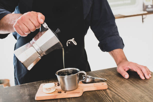 istock Male Barista preparing fresh espresso in coffee maker 1285077150