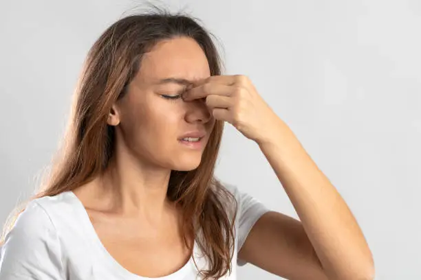 Photo of Young woman suffering from symptoms of sinus infection