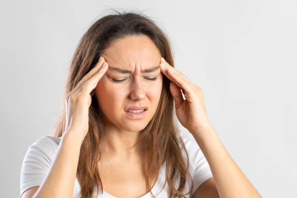 istock Girl suffering migraine on isolated gray background 1285077482