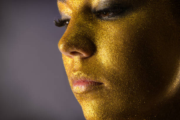istock close up portrait woman in gold 1285078521
