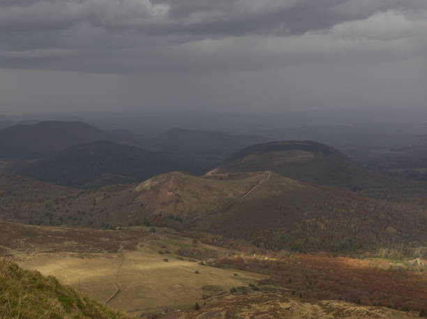 istock Impressive atmosphere between sun and rain on plains and domes from Puy de Dome 1285080282