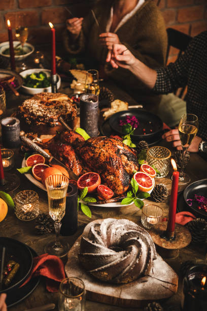 istock Family feasting over festive dinner with cake, roasted turkey, champagne 1285082433