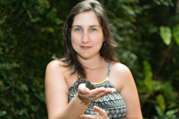 istock Hummingbird bird in hand.  Freedom concept. 1285083538