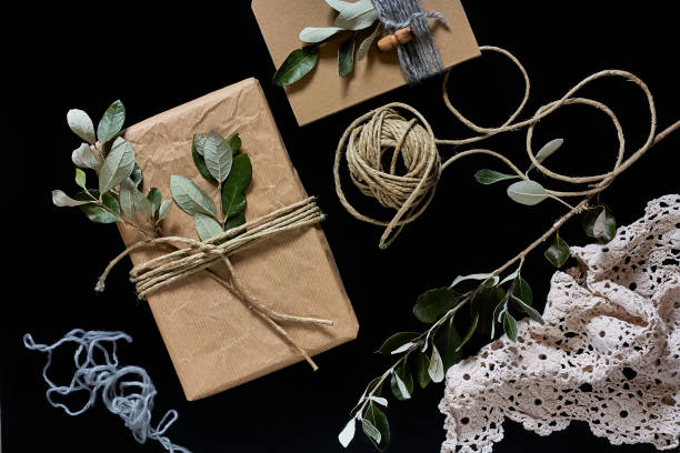 istock Chic cozy craft gift box on black background. Natural aestetic. Zero waste, plastic free, trendy hand made gift package for Christmas, Birthday, Easter. Top view. Copy space. 1285083743