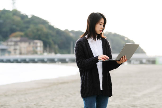 istock Young woman working from beach 1285083800
