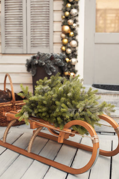 istock House christmas retro decorations in gold and silver colors. Sled with tree 1285083845