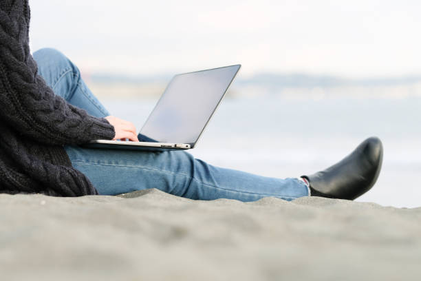 istock Young woman working from beach 1285083847