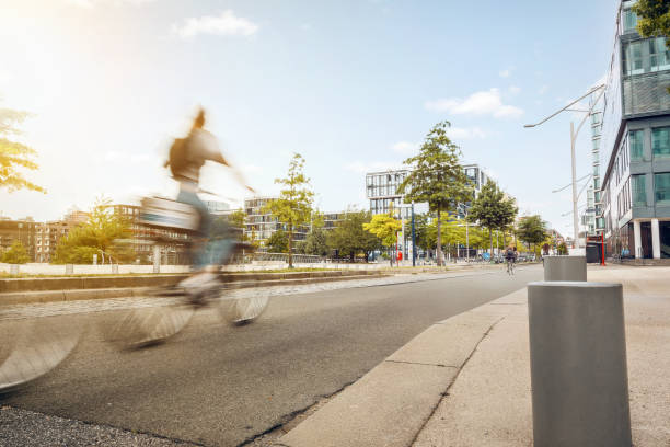 istock Street in a city with passing cyclist 1285084589