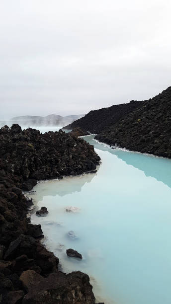 istock Blue Hot Spring River and Black Volcanic stone 1285086129