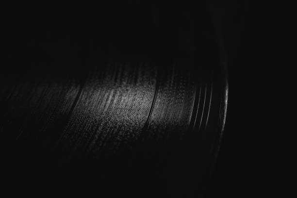 istock vinyl record on a black background macro photo. 1285086273