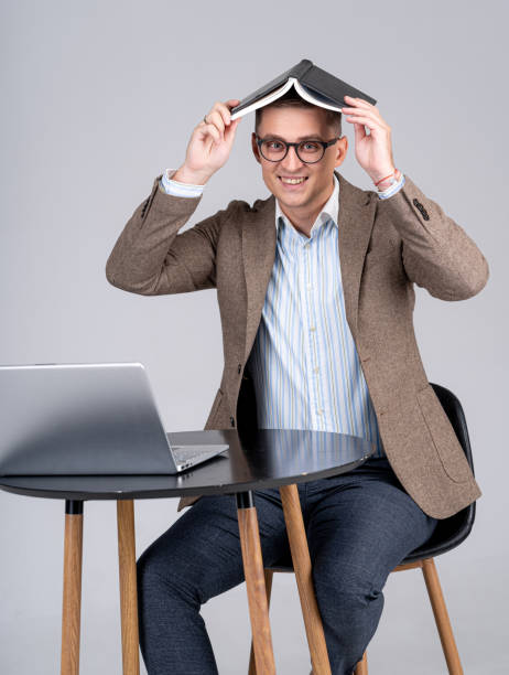 istock Good looking man covered head with notebook. Smiling manager having fun at work. Portrait at work. 1285086933