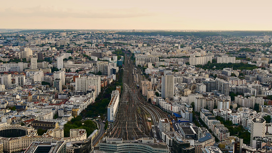 Aerial view of the eastern part of the historic city center of Paris, France with rail tracks leading to the train station Gare Montparnasse in the evening light.