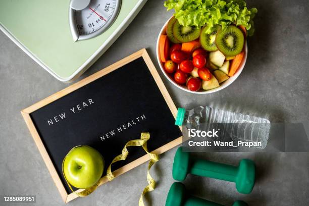 New Year For New Healthy 2021 Fresh Vegetable Salad And Healthy Food For Sport Equipment For Women Diet Slimming Weight Loss Background Stock Photo - Download Image Now