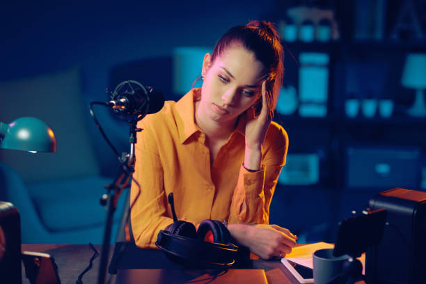 istock Tired radio host sitting at desk 1285090323