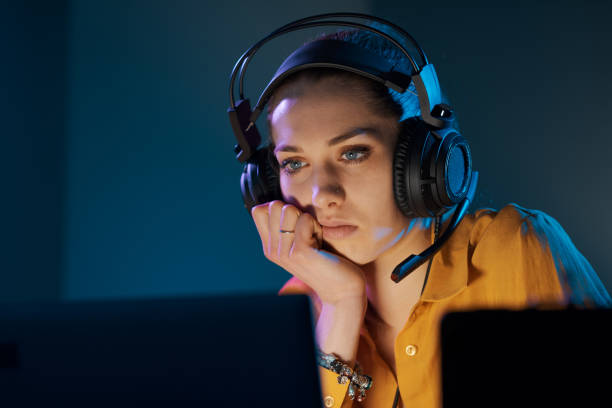 istock Young gamer playing online late at night 1285090504