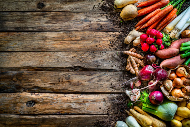 istock Healthy fresh organic root vegetables on rustic wooden table. Copy space 1285092016