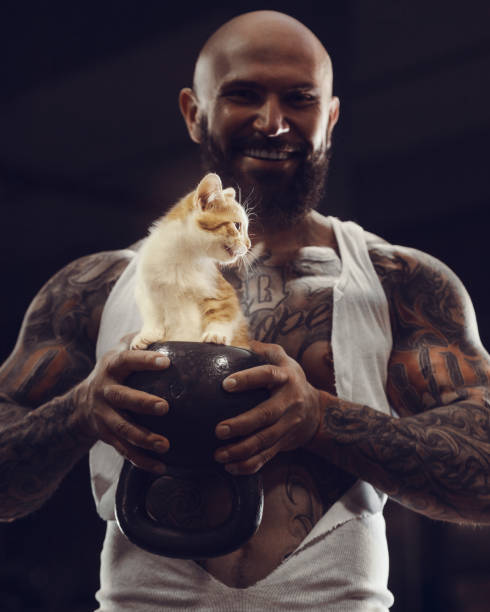 istock brutal tattooed man with cat 1285093082