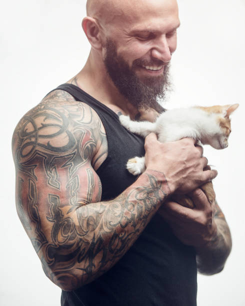 istock brutal tattooed man with cat 1285093123
