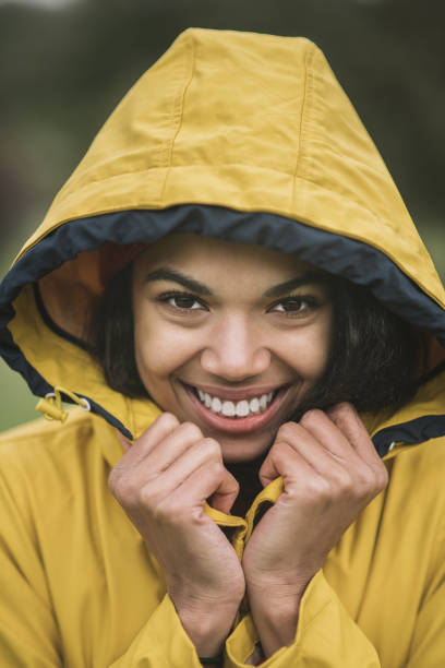 istock Pretty mulatta in yellow coat smiling happily 1285094698