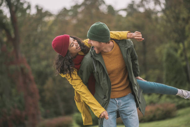 istock Cute couple walking in the park and looking happy 1285094749