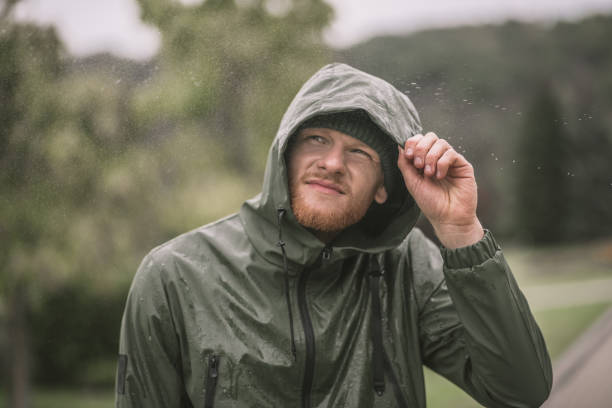 istock Young man in a hood watching the rain 1285094780