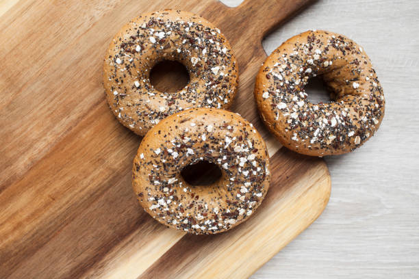 istock Multigrain bagels on a wooden board viewed directly above and with copy space 1285096471