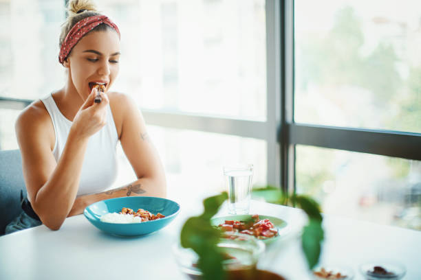 istock Young woman eating lunch alone at the restaurant. 1285097242