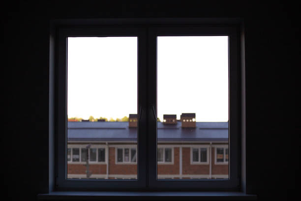 istock a window from a dark room overlooking the city rooftops. Quarantine and self-isolation, diplomatic mood 1285097875