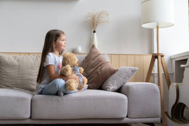 istock Positive smiling school girl lying on a couch 1285097926
