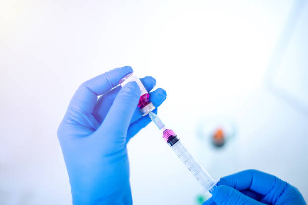 istock Doctor using syringe and vaccine for patients 1285099465