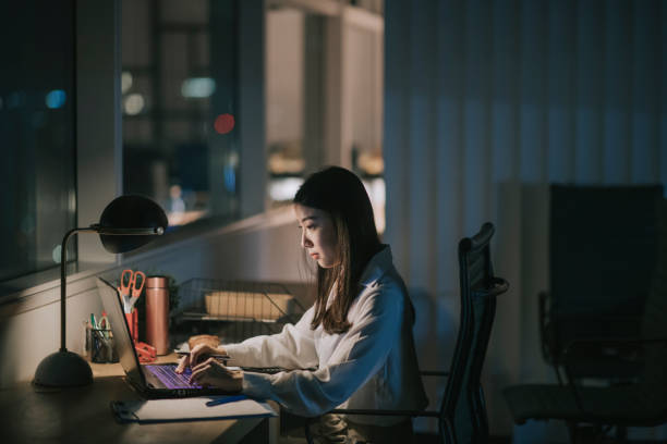 istock asian chinese female white collar worker working late in office alone at night rushing for financial report 1285099683