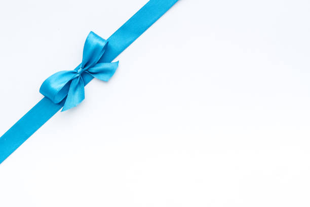 istock Blue ribbon with bow isolated on white. Top view, copy space 1285100762