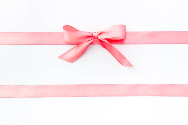 istock Pink ribbon with bow isolated on white for gift box. Top view, copy space 1285102217