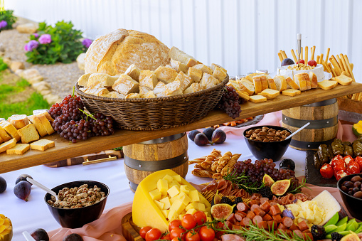 Party table. Variety or assortment of cheese, fruits and deli. Close up.