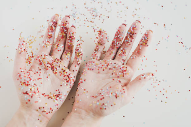 istock Female's hands covered with shiny glitters. Creativity concept. Art work creation 1285103711