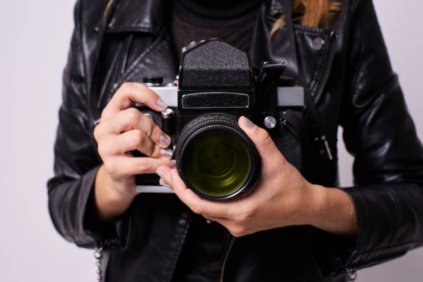 istock Retro camera. Girls hands. White background 1285103825
