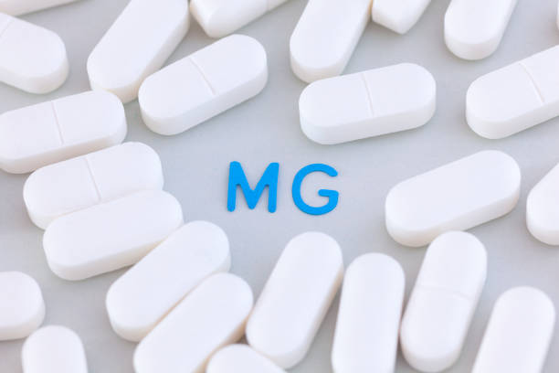 istock Magnesium pills around the symbol Mg 1285104915
