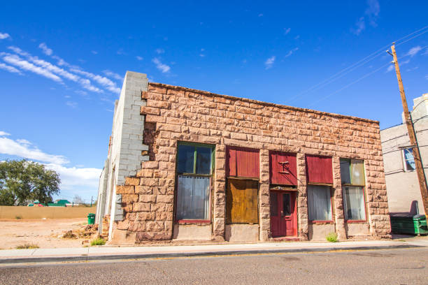 istock Old Closed Brick Store Front Building With Boarded Up Windows 1285105455