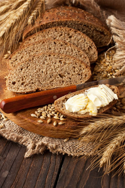 istock Sliced wholegrain sourdough  bread on wooden board 1285106526