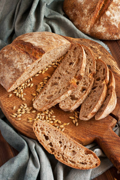 istock Freshly baked sourdough  bread on wooden cutting board 1285106561