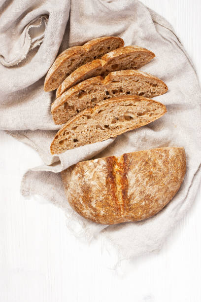 istock Fresh wheat and rye loaf of bread, rustic style 1285106606