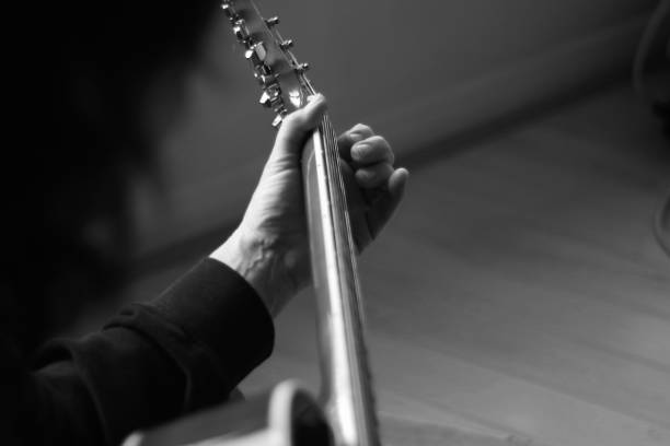 istock Close up of hands playing an acoustic guitar 1285106733