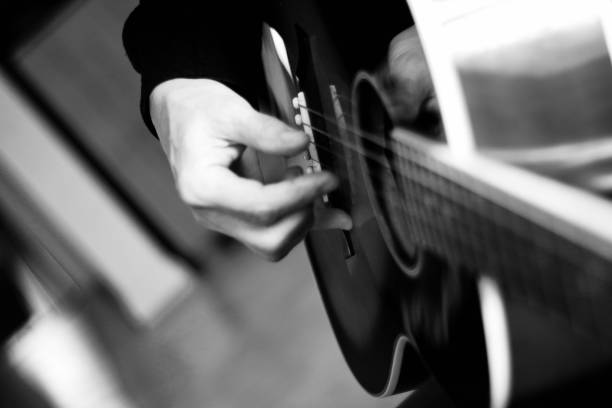 istock Close up of hands playing an acoustic guitar 1285106750