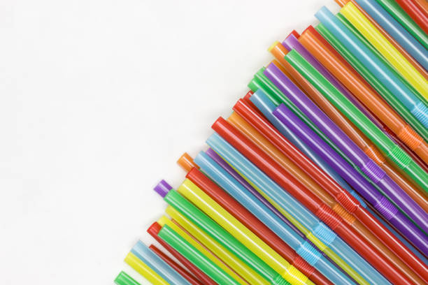 multicoloured plastic straws on a white background with copy space. celebration and party background - drinking straw plastic design in a row imagens e fotografias de stock