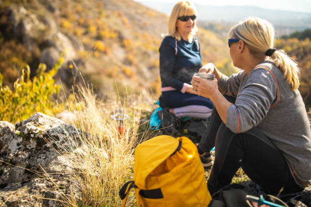 istock Three female friends taking a break for refreshment during hiking on beautiful day 1285109803