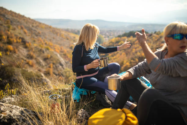istock Three female friends taking a break for refreshment during hiking on beautiful day 1285110005